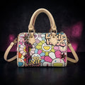 Daisy Luxe Mini floral designer handbag front view with top handle and signature keychain charm by Luxie Haus