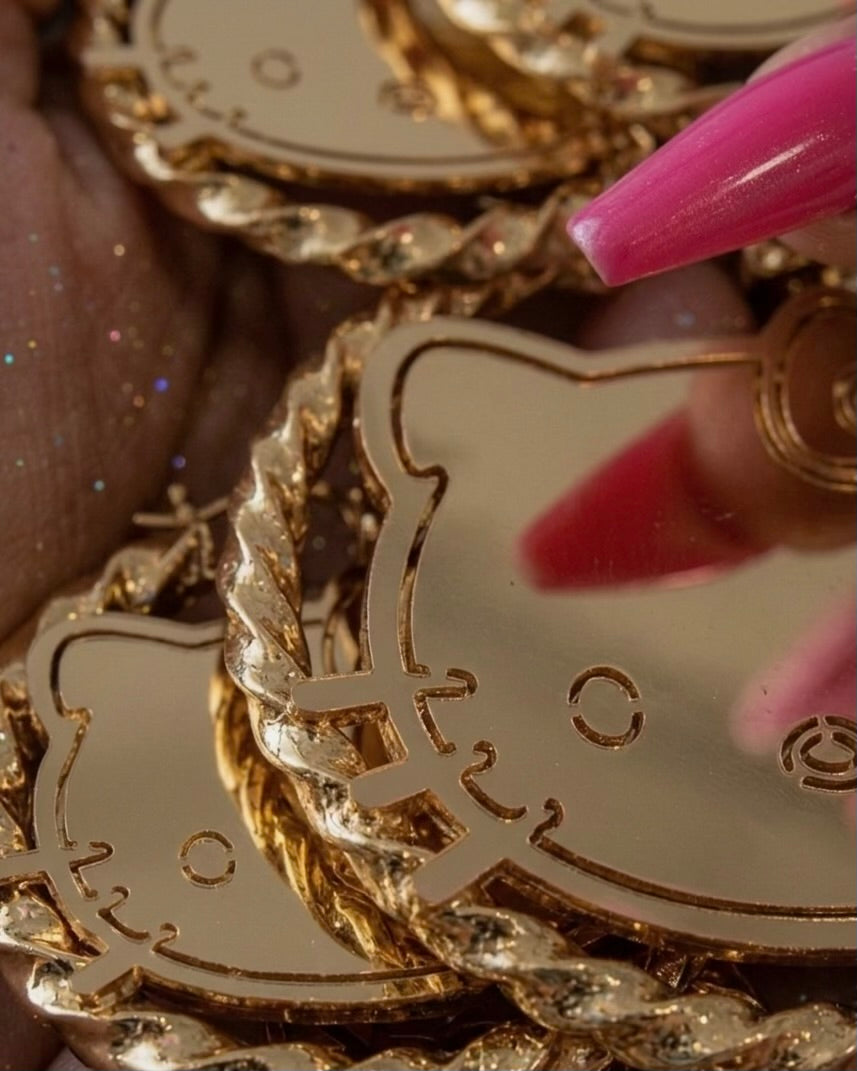 Detailed close-up oversized gold cartoon face hoop earrings stainless steel