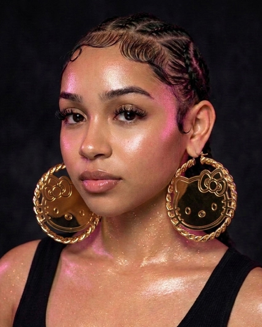 Model wearing oversized cartoon face gold hoop earrings stainless steel statement jewelry