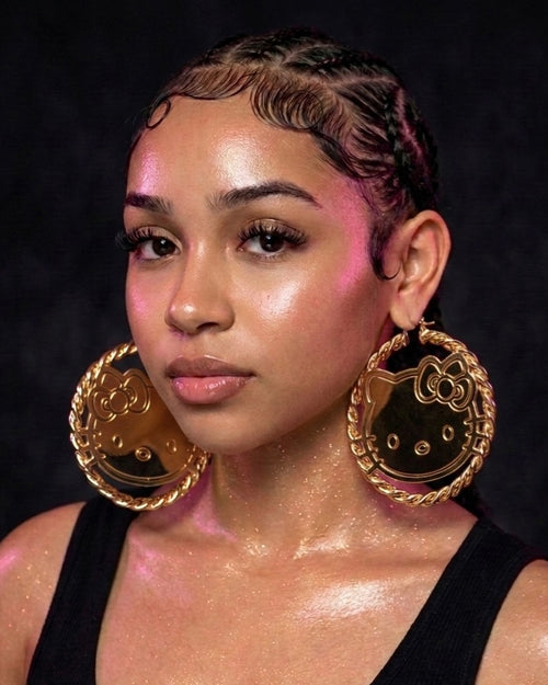 Model wearing oversized cartoon face gold hoop earrings stainless steel statement jewelry